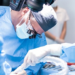 an oral surgeon performing the dental implant placement procedure