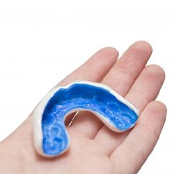 blue mouthguard in a person’s hand 