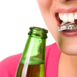 close-up of a person with a bottle cap in their mouth