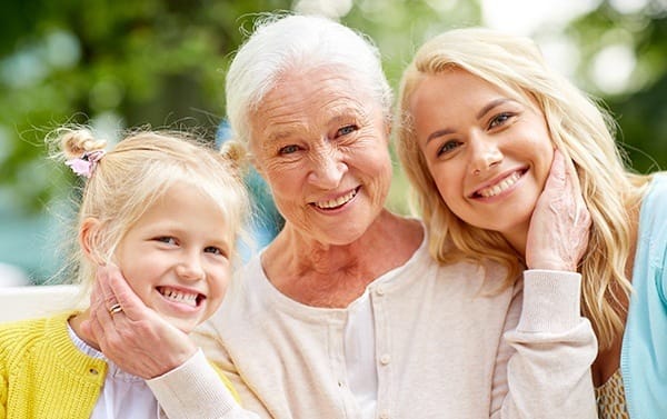 Smiling grandmother, mother, and daughter