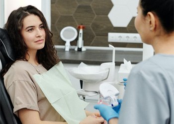 Dentist speaking with female patient