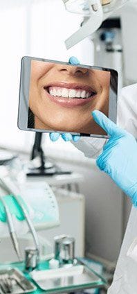 Dental patient's smile refelcted in mirror