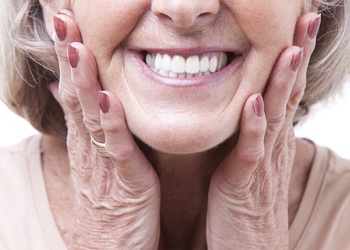 Closeup of smiling older woman wearing dentures in Falls Church