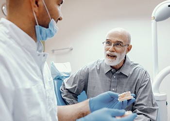 senior man asking his dentist questions about dentures in Falls Church 