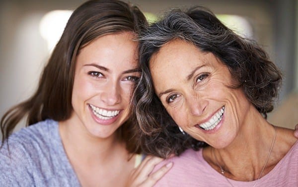 Smiling mother and adult daughter