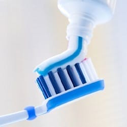 toothpaste being put on a toothbrush