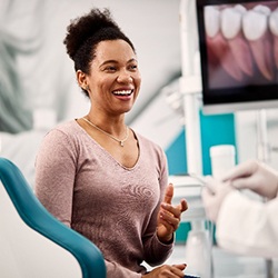 Smiling woman talking to dentist during Invisalign consultation