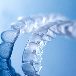 Invisalign clear aligners against blue background