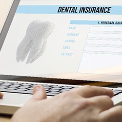 Patient looking at dental insurance paperwork on computer