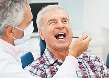 Senior man receiving dental exam