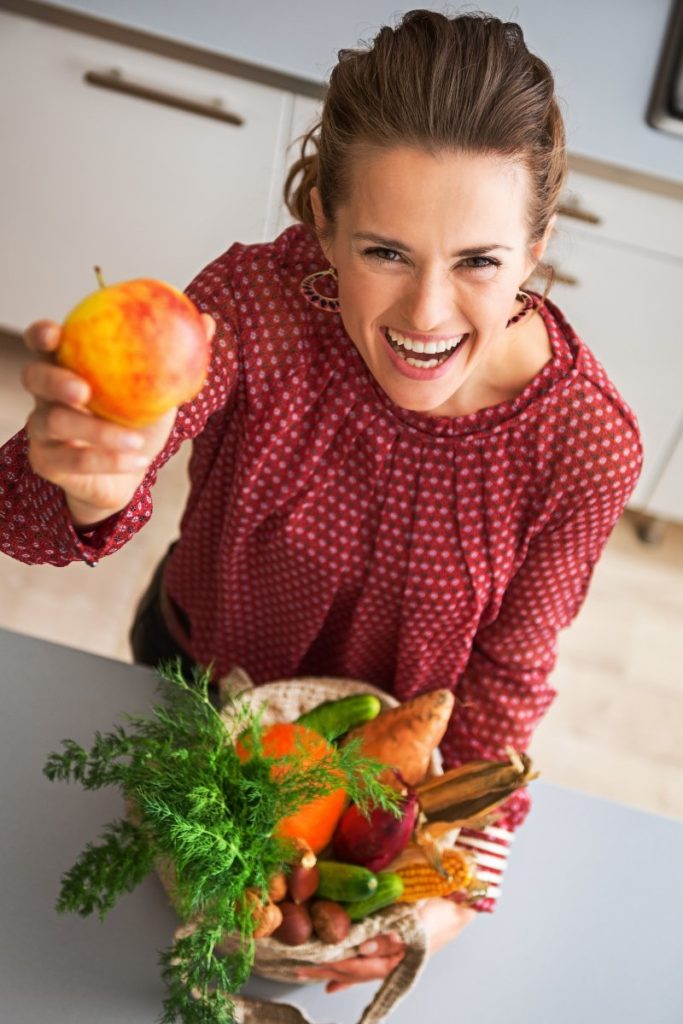 Woman holding a cornucopia and smiling